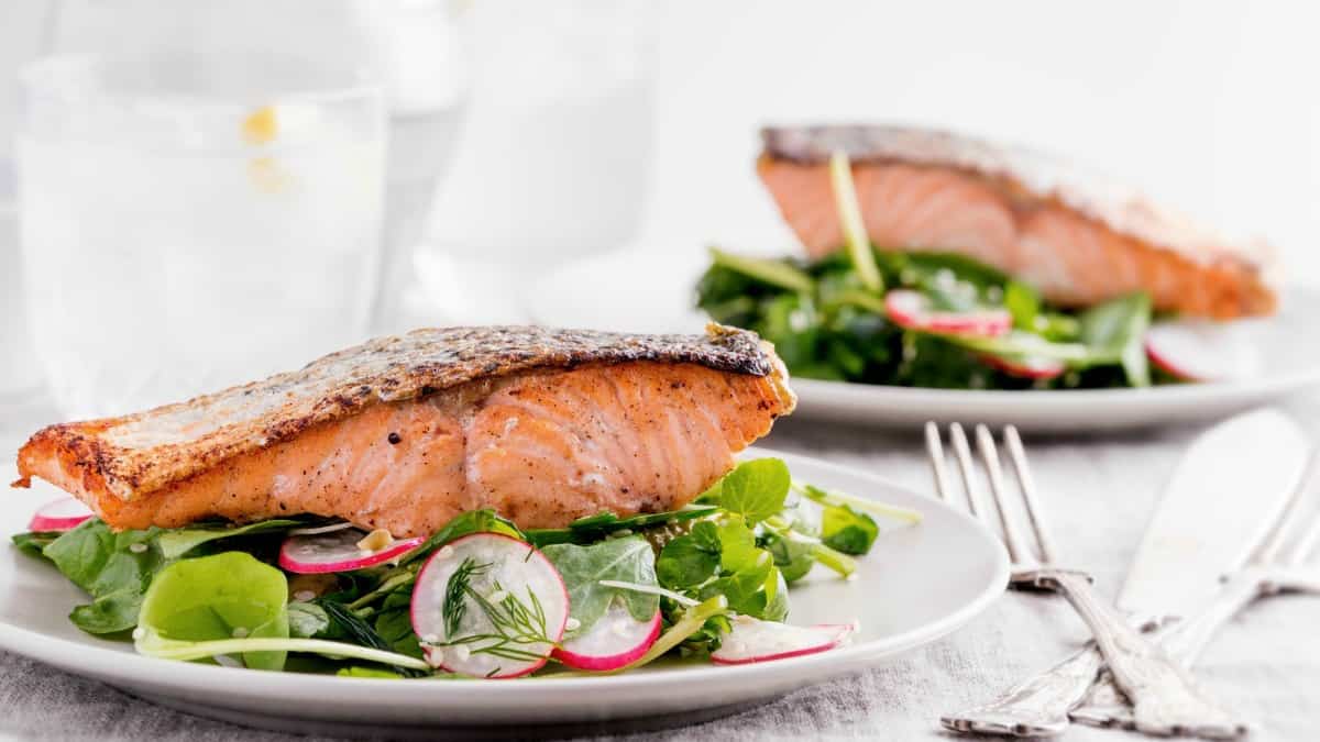 salmon arugula salad on plates