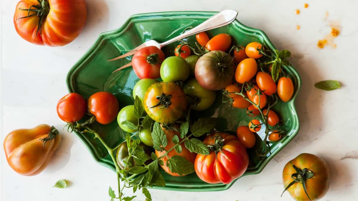 a bowl of colorful fresh heirloom anti inflammatory tomatoes