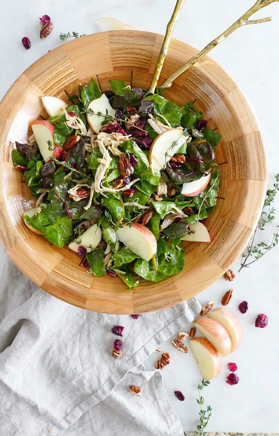 Maple Swiss Chard Salad with Turkey in wooden bowl with cranberries