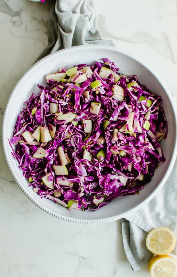 Red Cabbage Apple Slaw with Tangy Honey Dressing in white bowl
