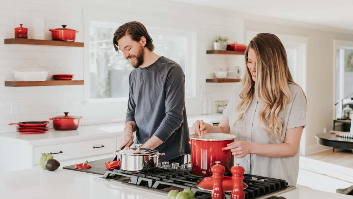 couple cooking in the kitchen with good food handling safety