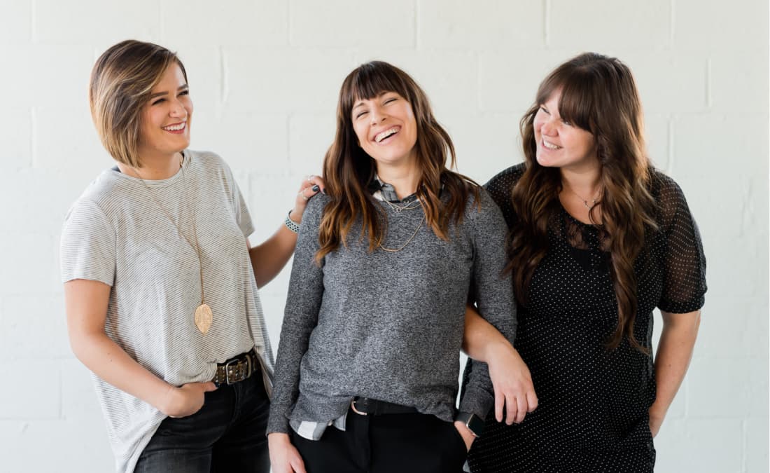 three women smiling together showing gratitude