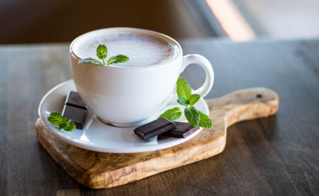 holiday coffee drink peppermint mocha on wooden board