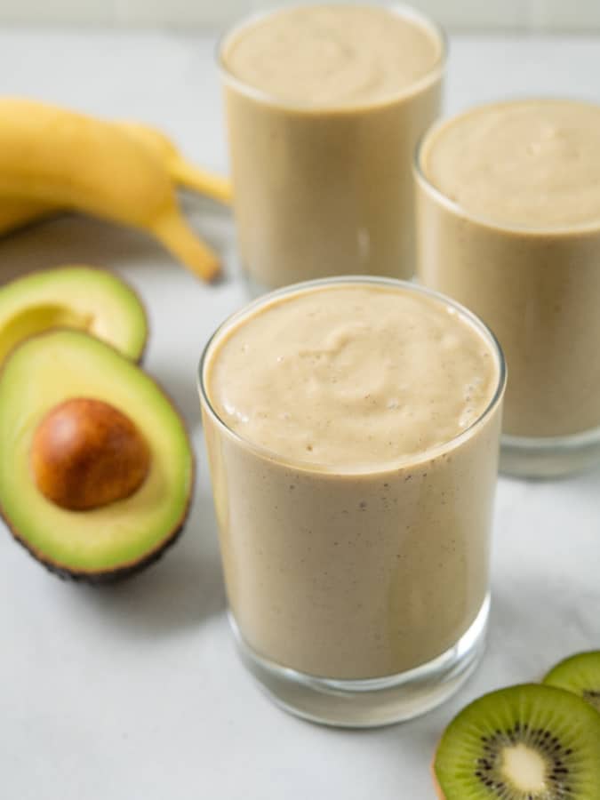 close up of potassium smoothie in cups with avocado and banana