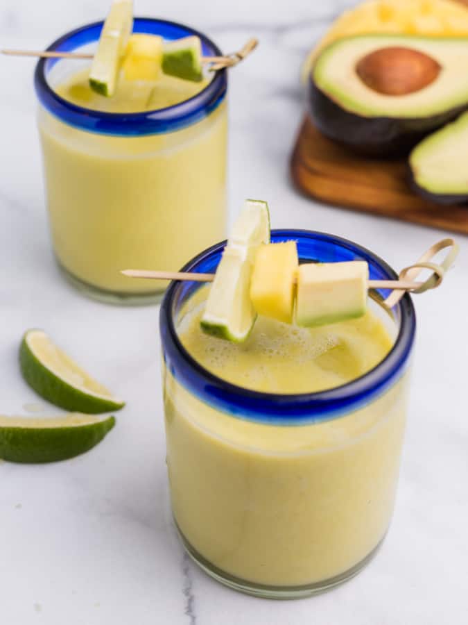 avocado mango margaritas with lime, mango, and avocado skewer