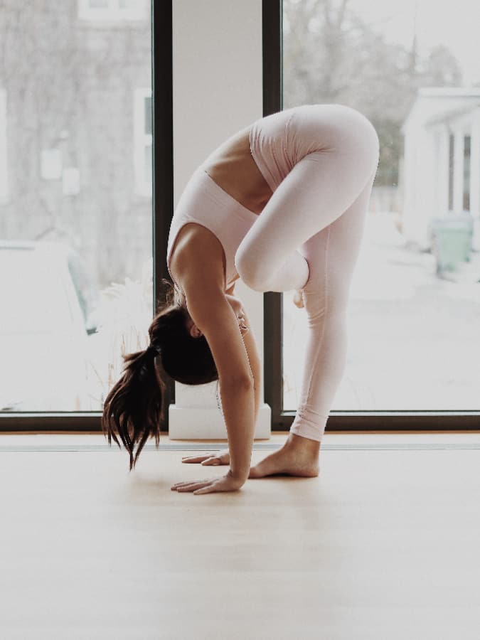 woman holding a yoga pose to feel more energized