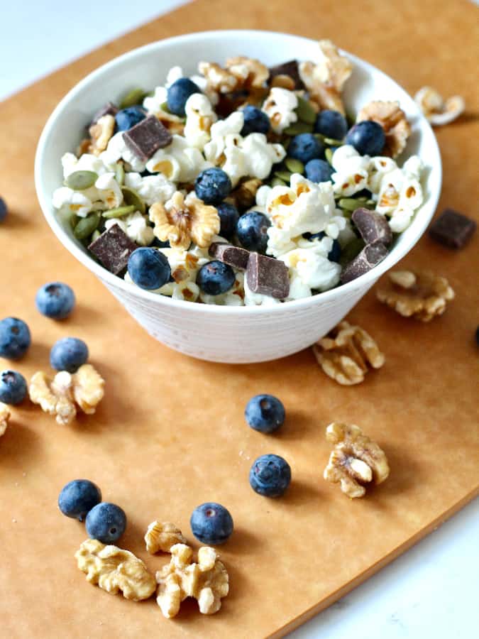 blueberry popcorn trail mix in a white bowl