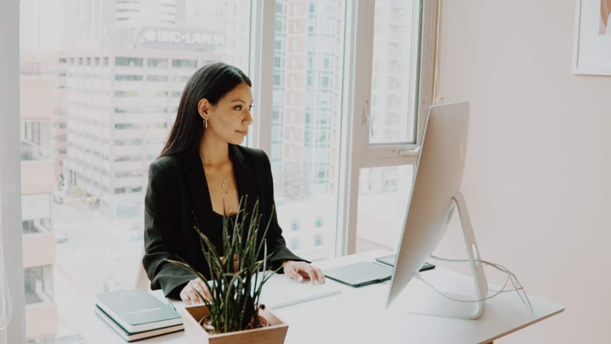 woman working at desk reading about foods that help you focus