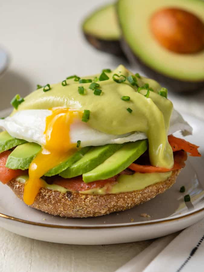 close up of avocado eggs benedict with avocado hollandaise