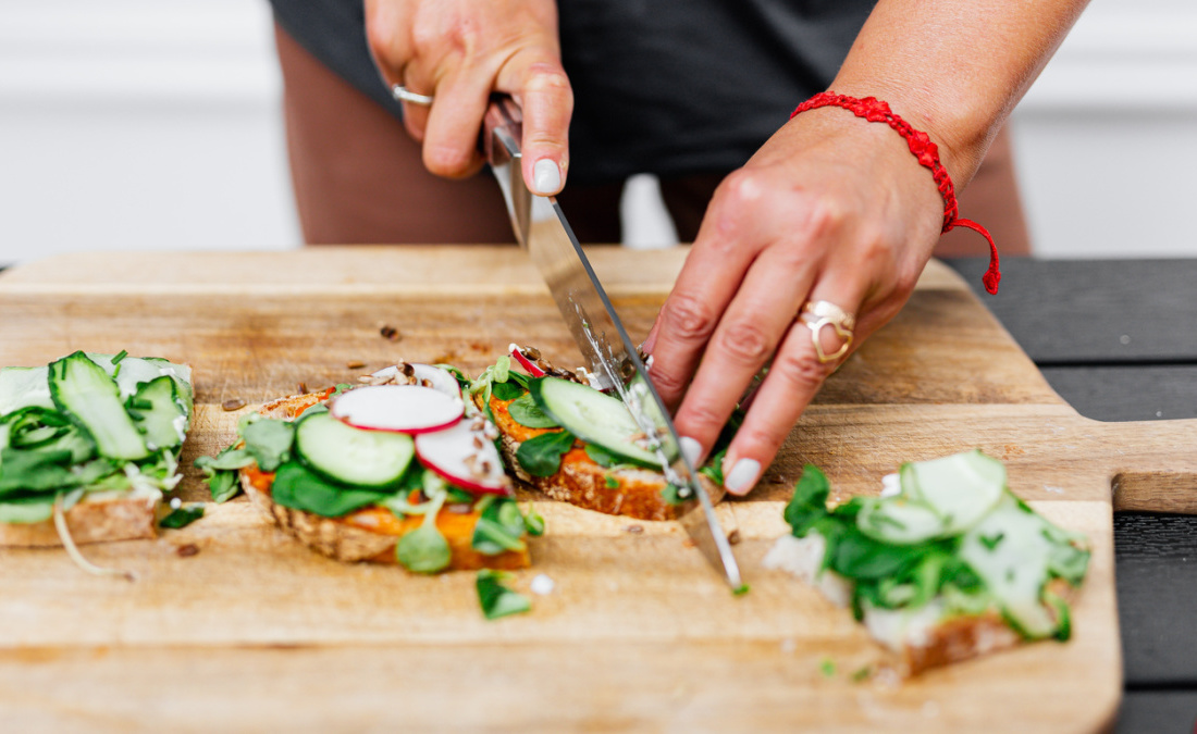 are vegan sandwiches healthy woman cutting veggie with bread