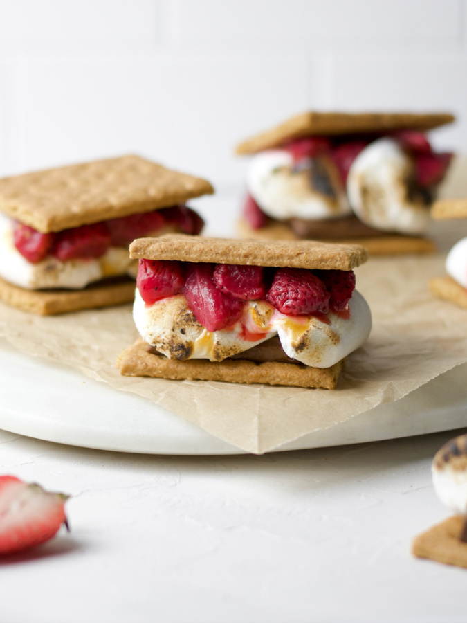strawberry s'mores with toasted marshmallows on a counter