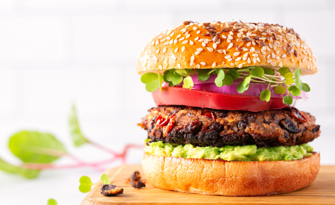 plant-based burger with veggies and whole grain bun
